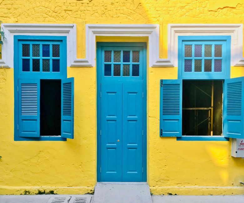 Painted house wall with a bright door and window frames