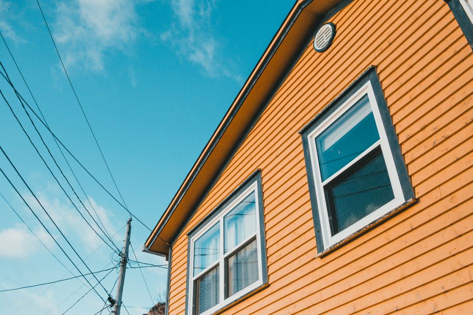 Painted wooden house exterior under a blue sky