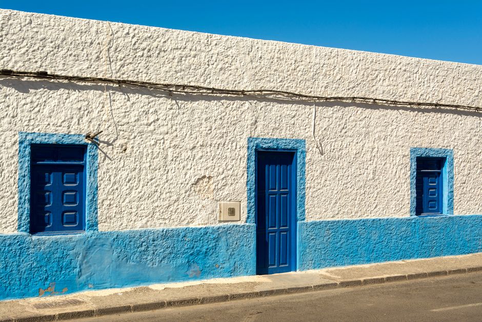Painted house front under a clear sky