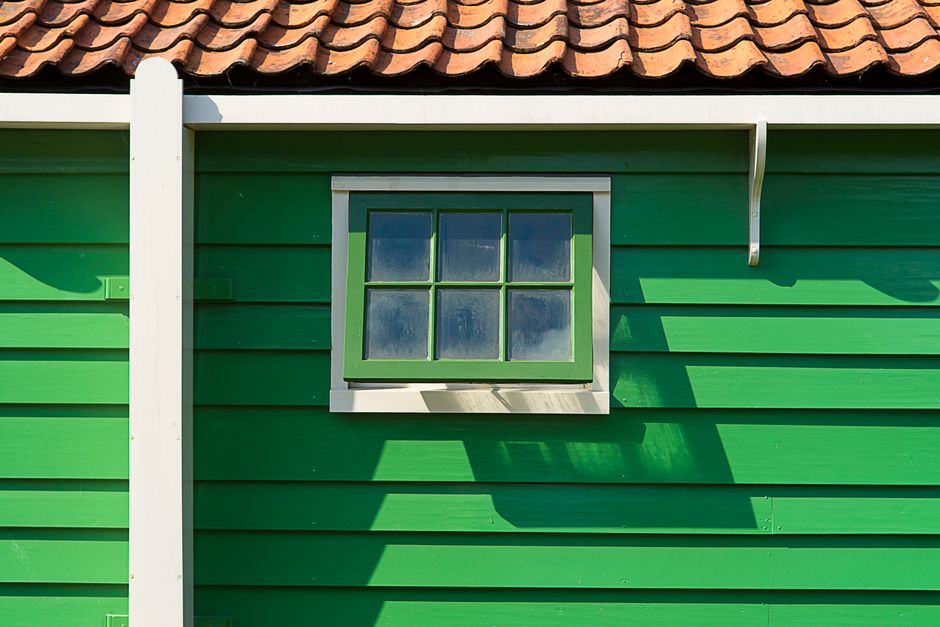 Close-up of a painted wooden house wall and window