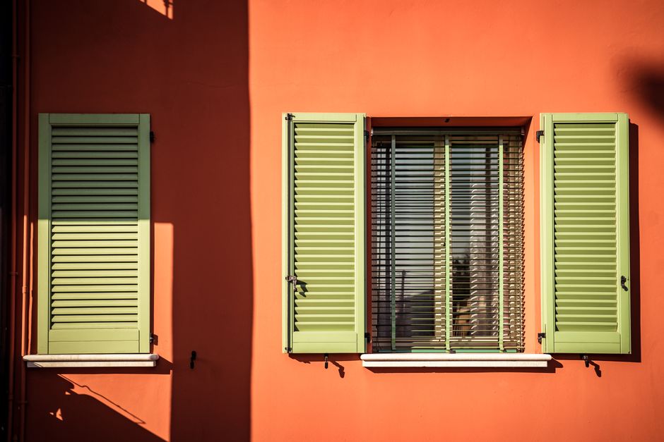 Painted exterior wall with green shutters